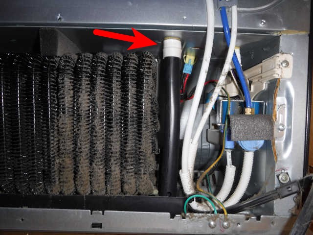 defroster drain pipe as seen from back of refrigerator